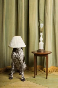 A lamp and table with curtains in the background